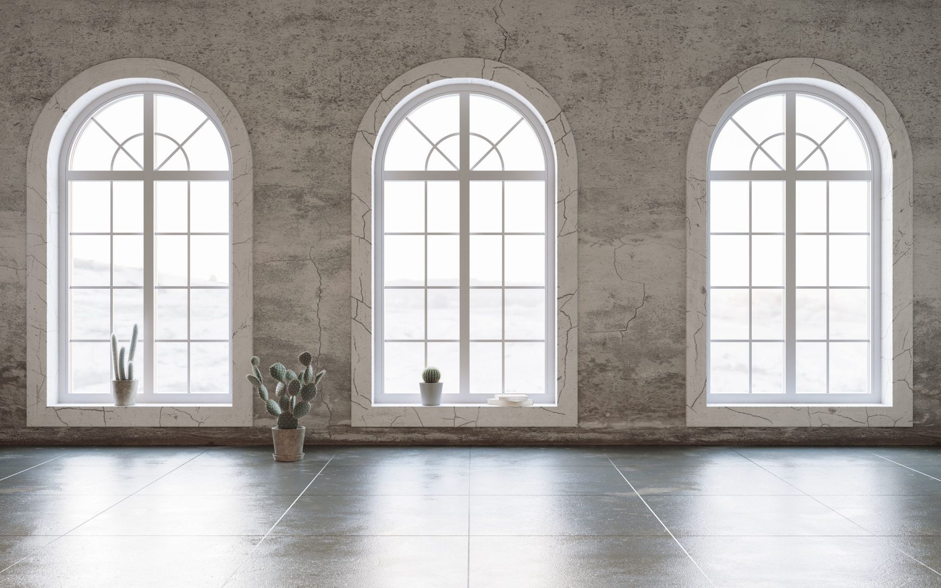 Three arched windows in a room with a concrete floor and distressed wall, plants on the window sills