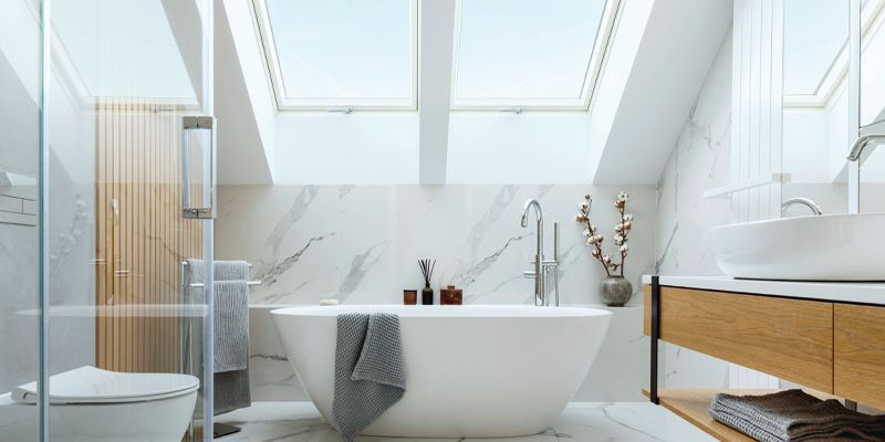 Modern bathroom with a bathtub under skylights