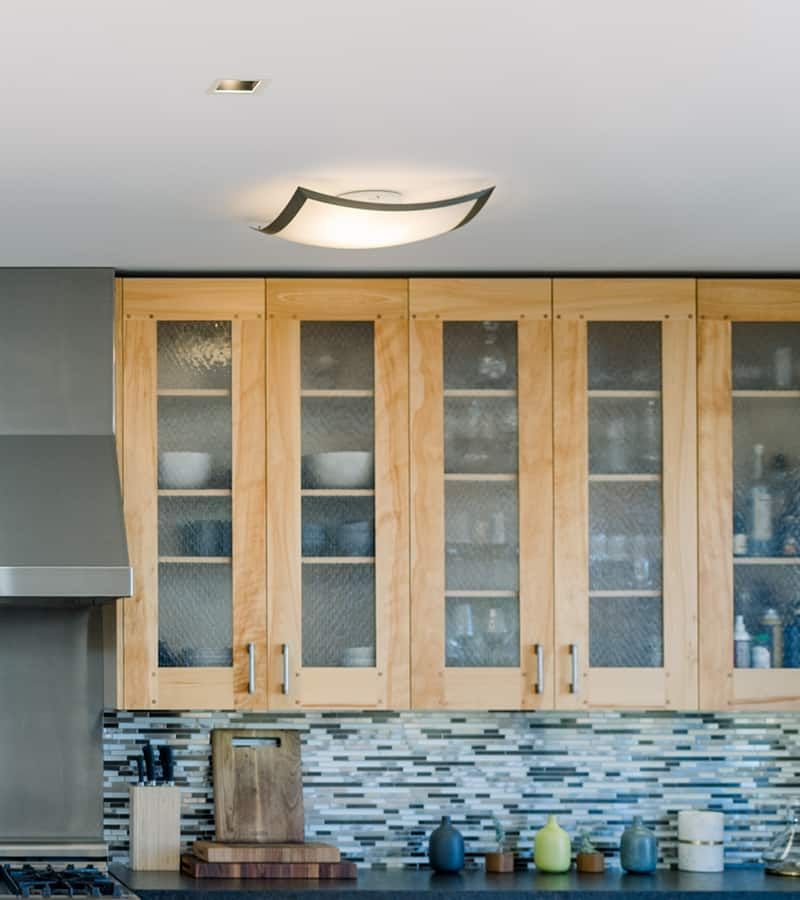 A spacious, well-lit kitchen featuring wooden cabinetry