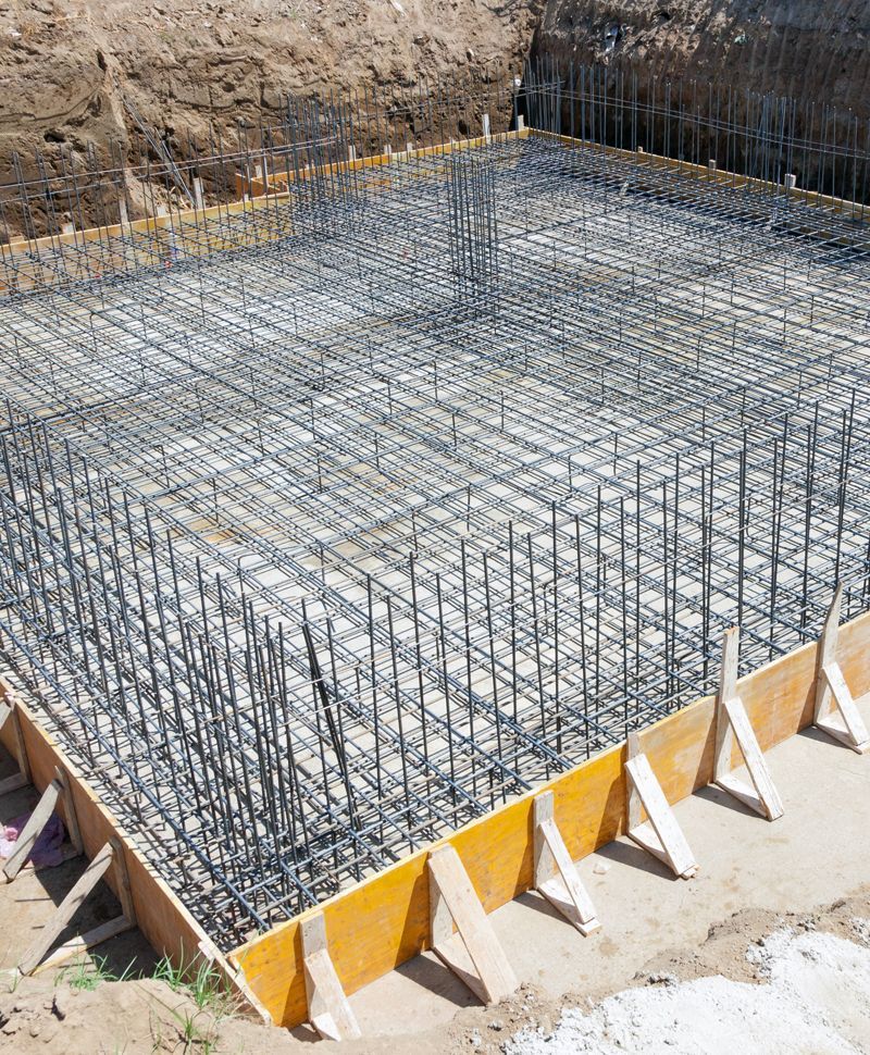 Reinforced concrete foundation formwork, with steel rebar grid in preparation for pouring concrete