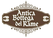 Un logo marrone di forma ovale con bordi decorativi a volute, contenente la scritta bianca 