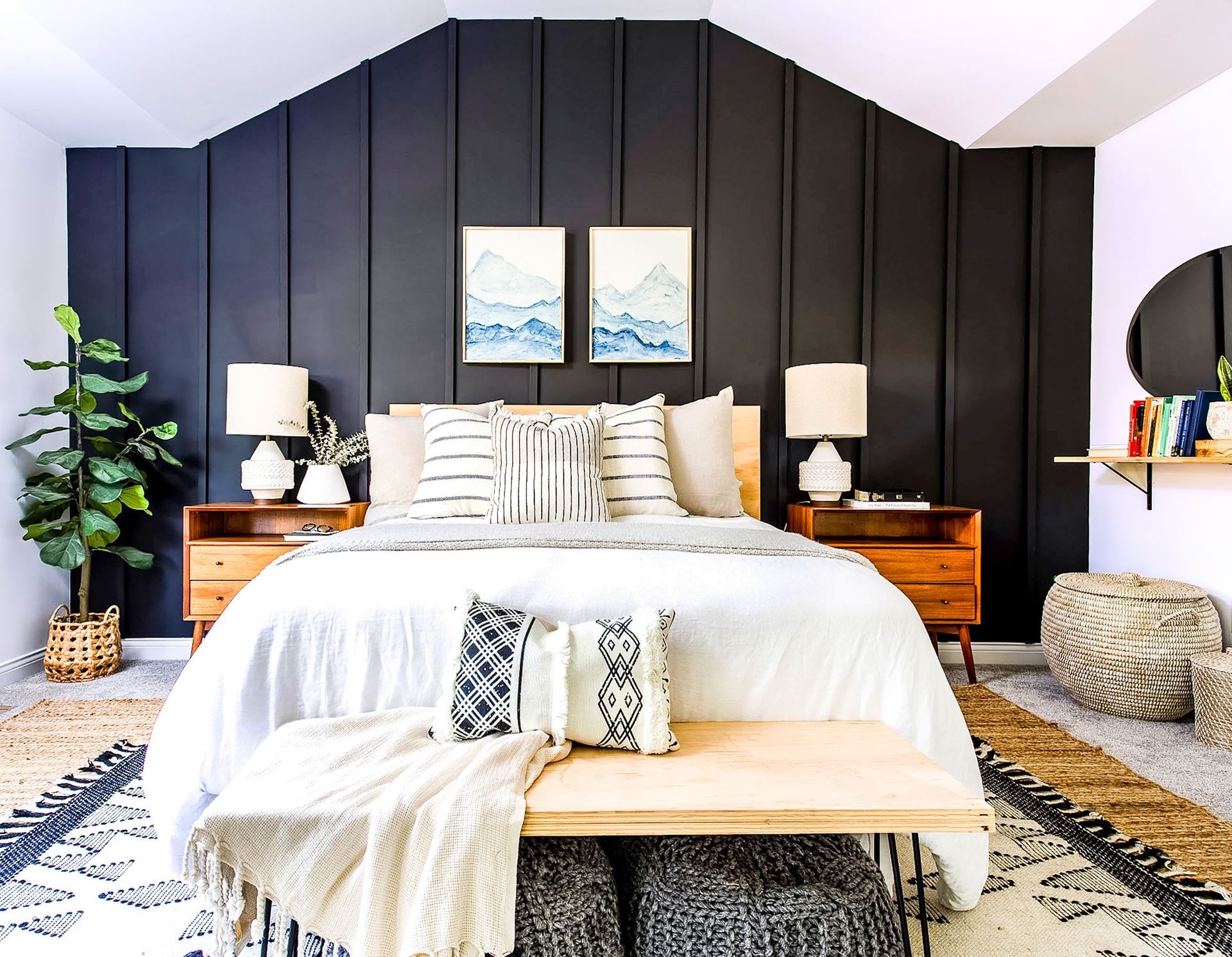 Bedroom with a striking black accent wall showcasing bold elegance and contrasting textures.