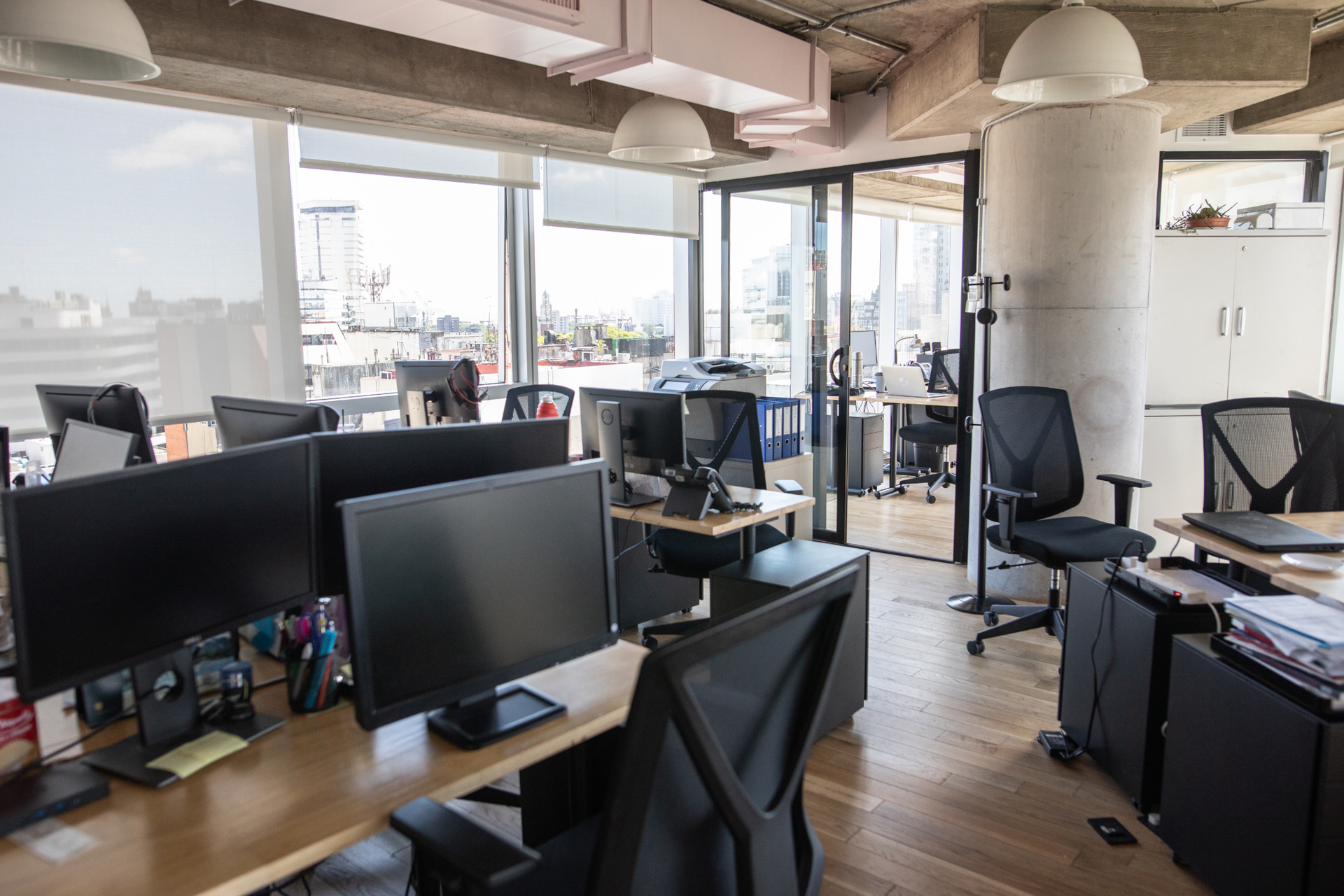 Older man with beard signing document, woman smiles beside him at a table.