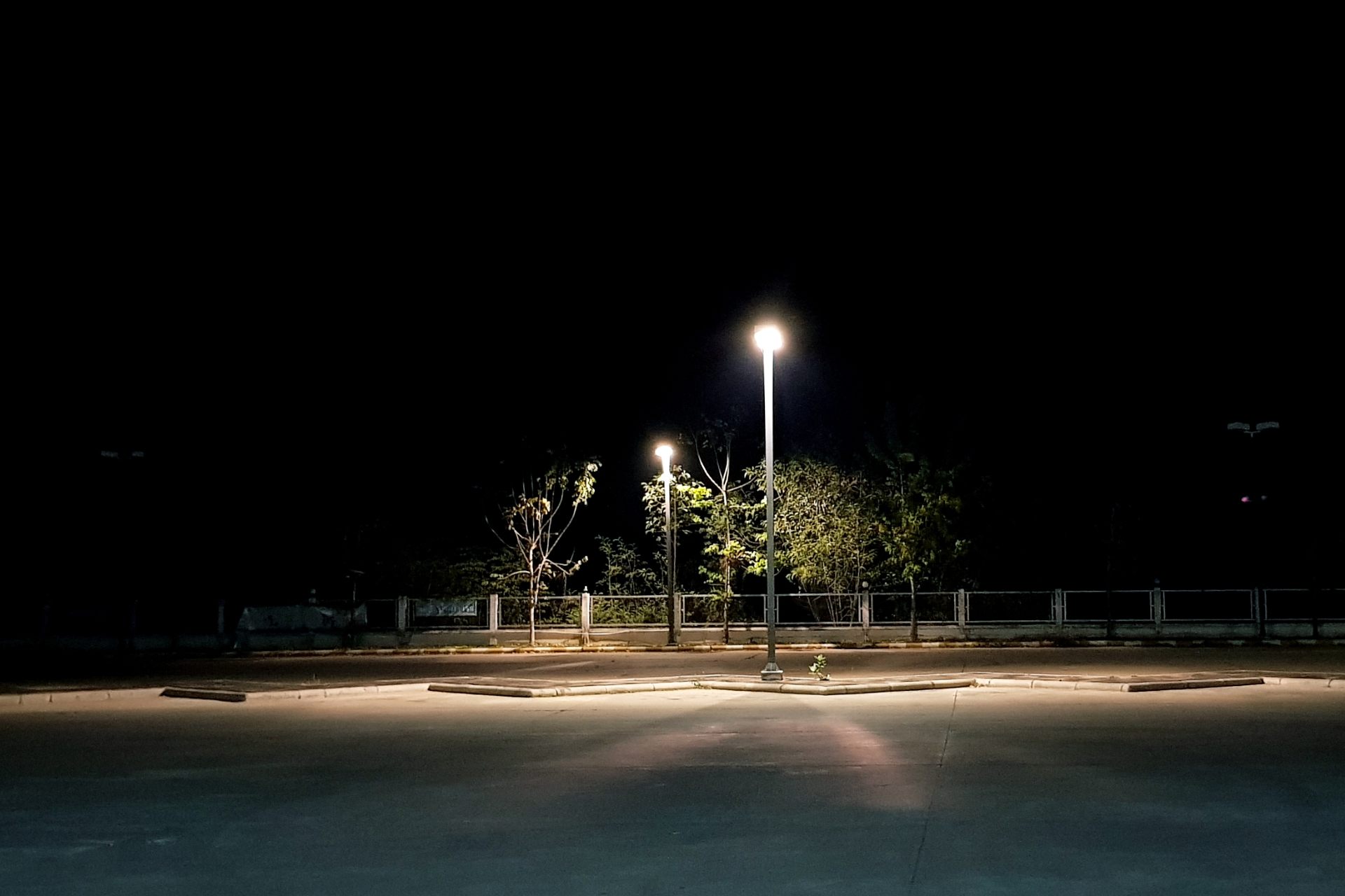 Older man with beard signing document, woman smiles beside him at a table.
