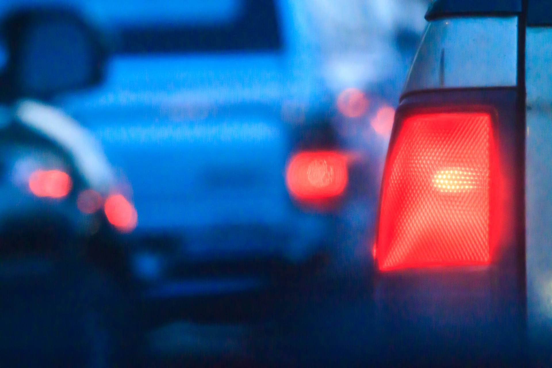 Older man with beard signing document, woman smiles beside him at a table.