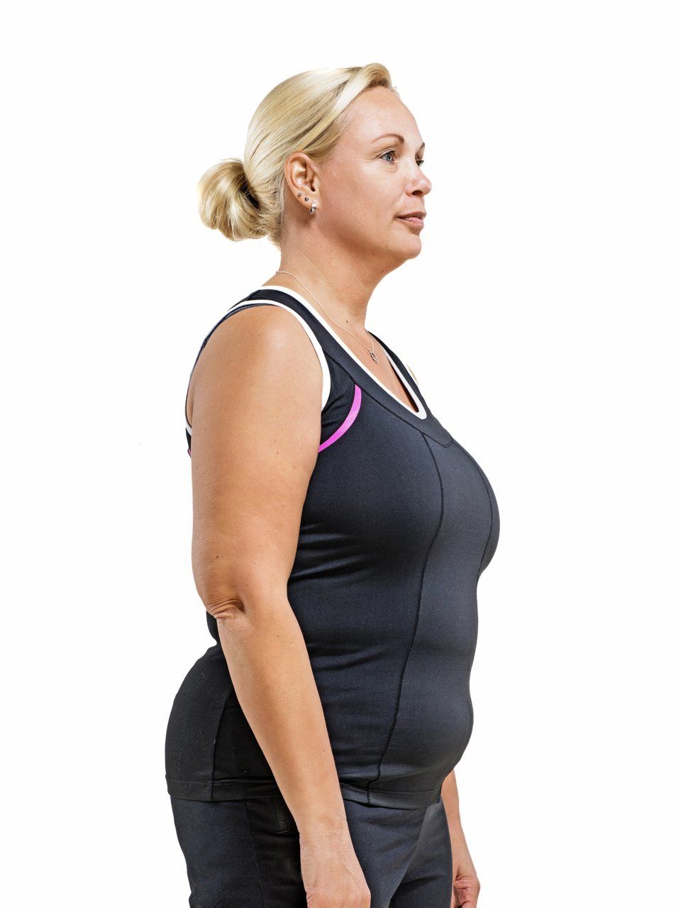 a woman in a black tank top is standing in front of a white background