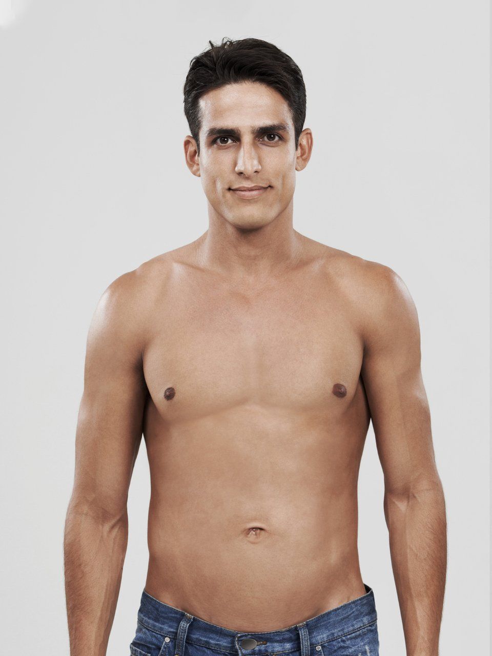 a shirtless man is standing in front of a white background