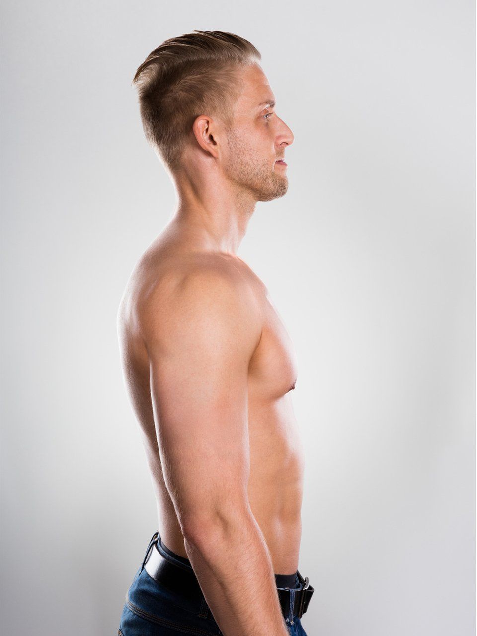 a shirtless man is standing in front of a white background .
