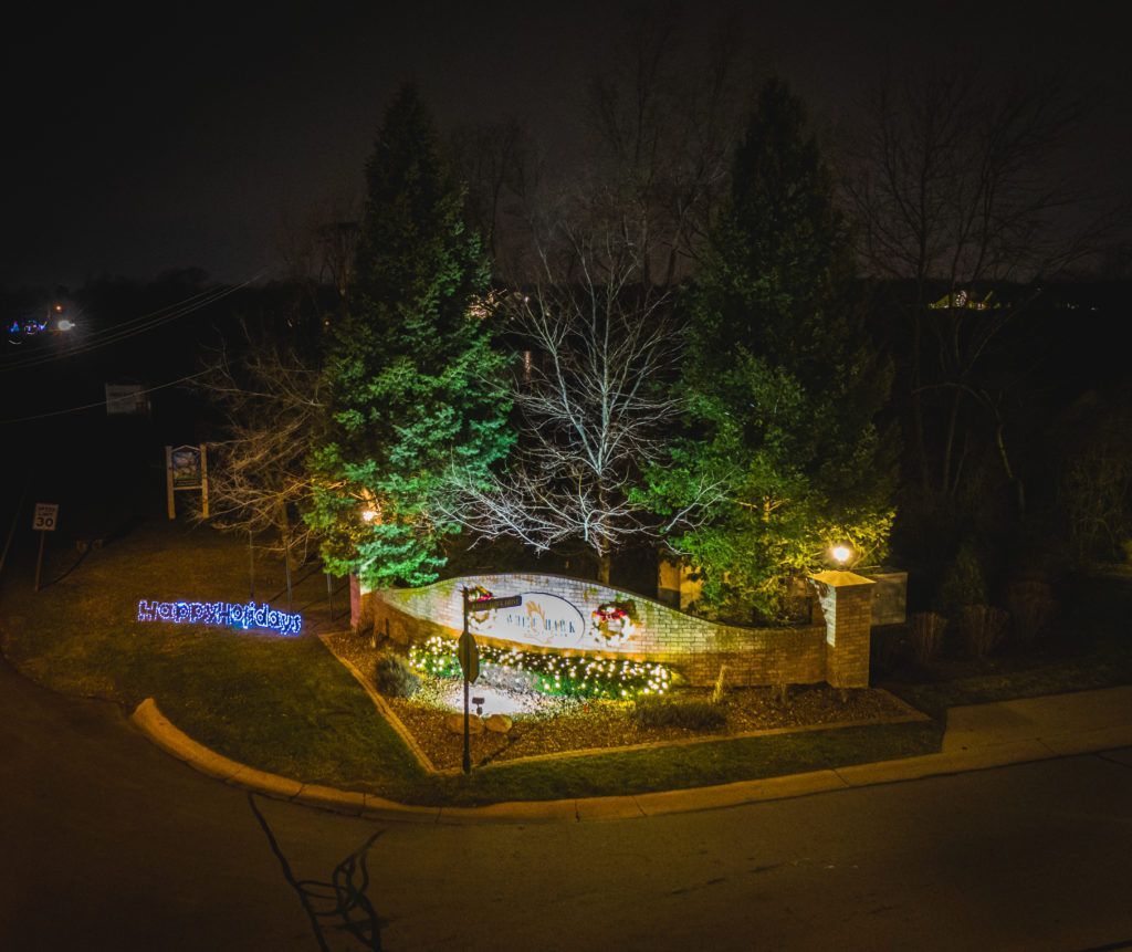 An aerial view of a sign that is lit up at night.