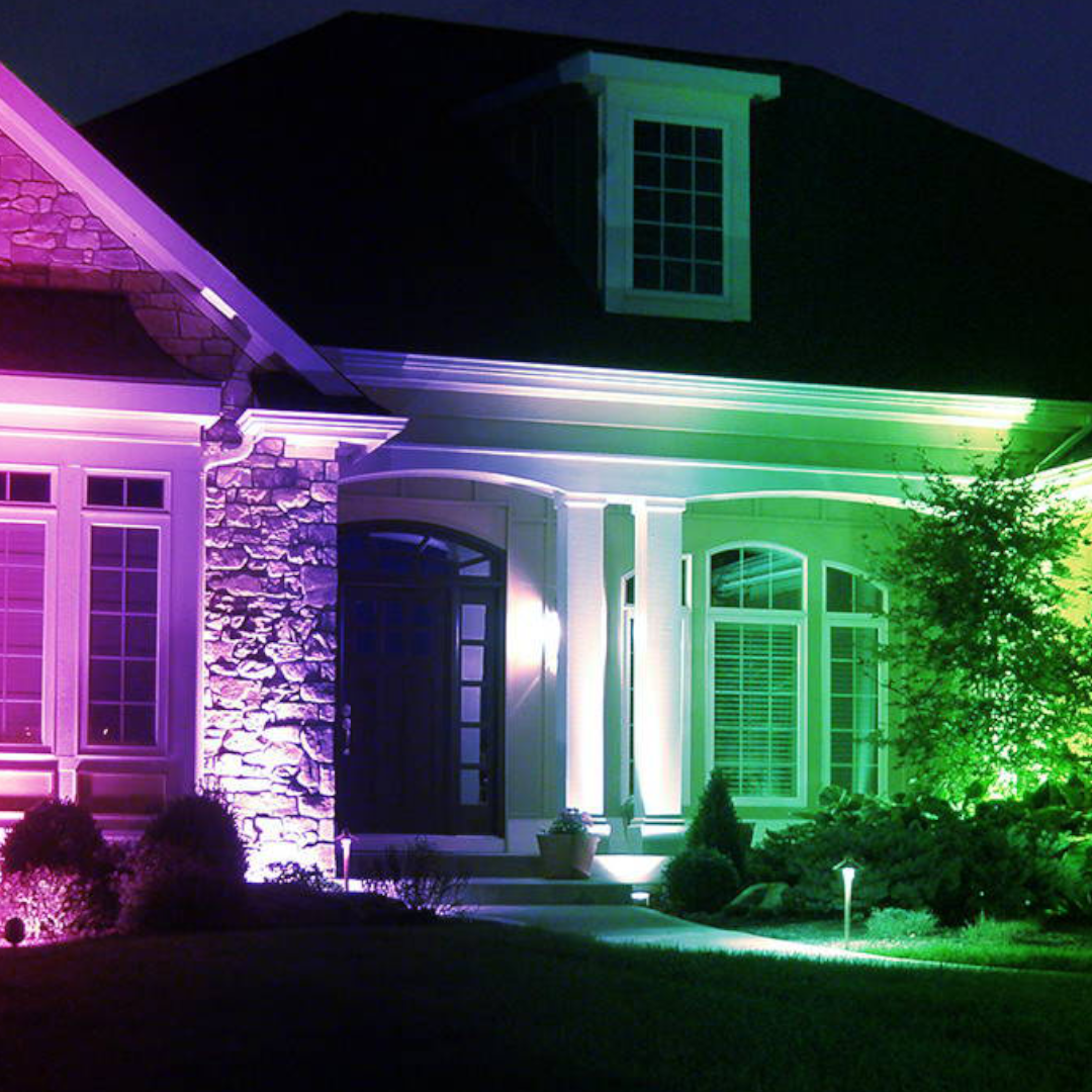 A house with christmas lights on the side of it at night.