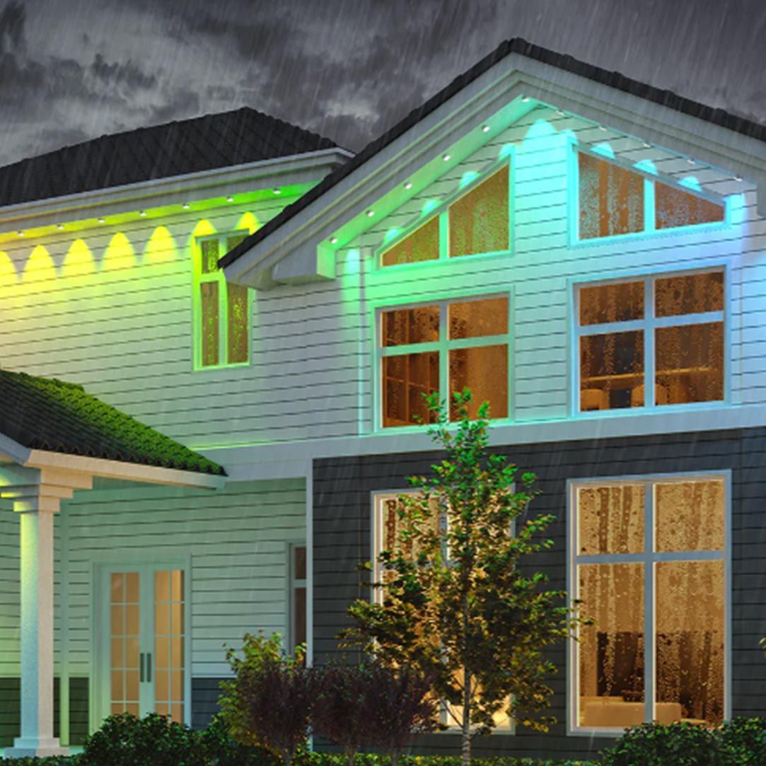 A house with a lot of windows and green lights on it