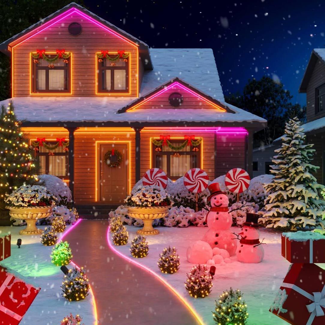 A house decorated for christmas with a snowman and candy canes