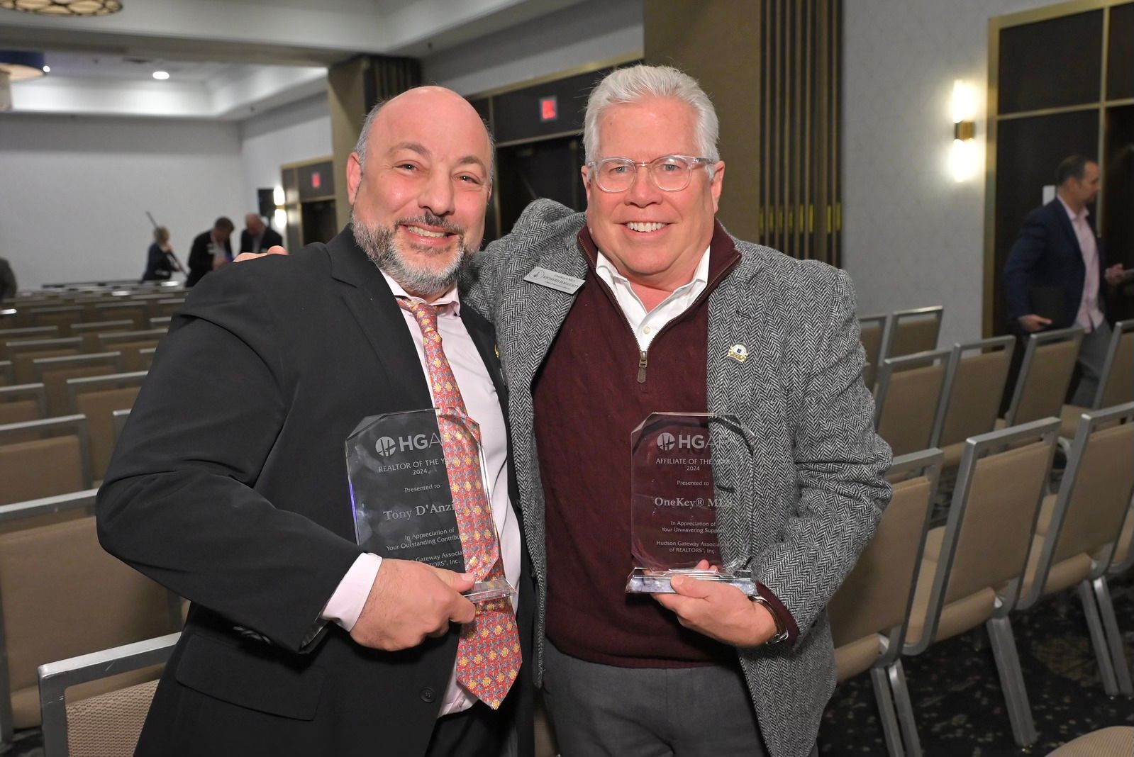 Tony D'Anzica and Richard Haggerty posing for a picture while holding awards.