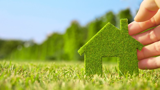 A green house in a field