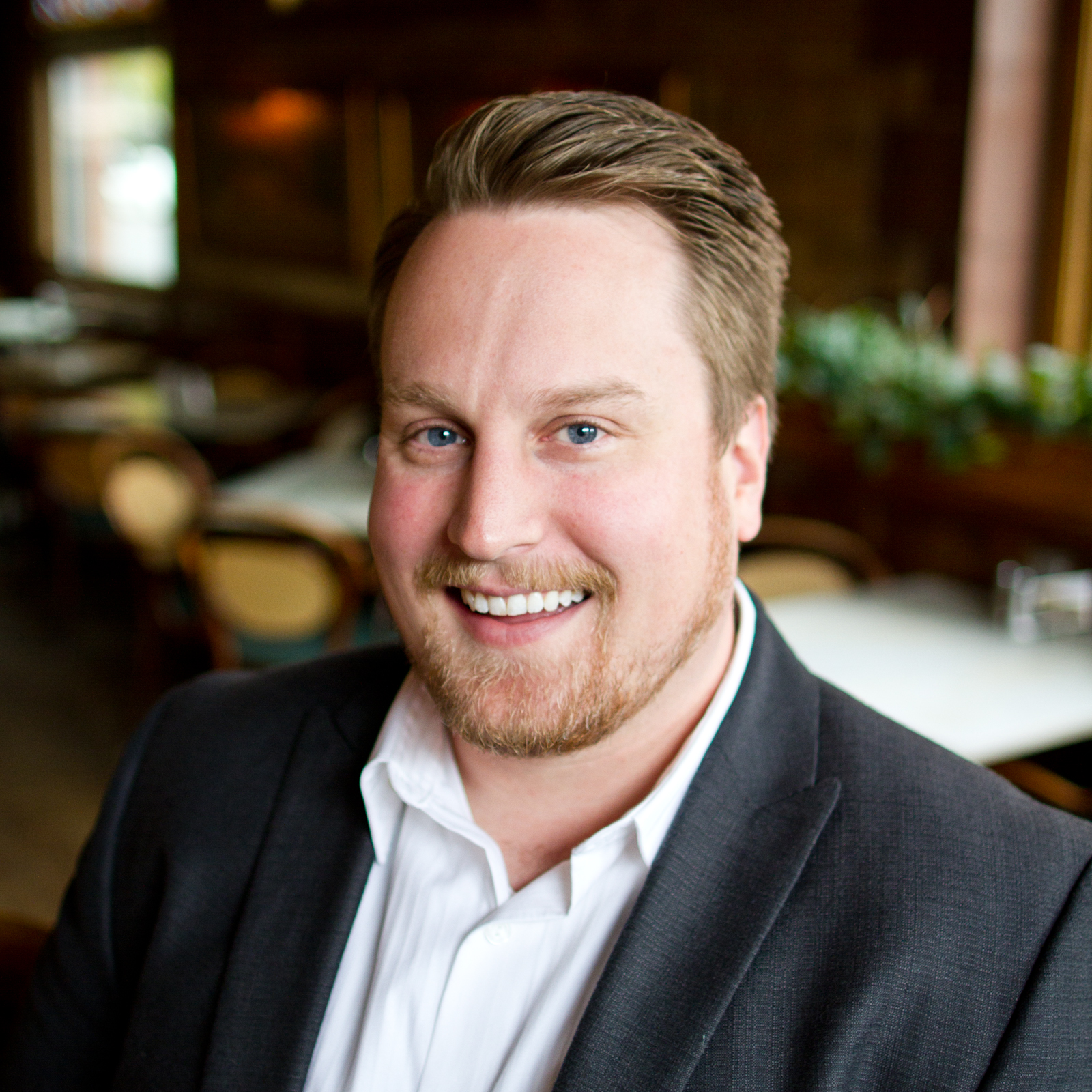 Mitch skinner, Esq in a suit and white shirt is smiling for the camera.