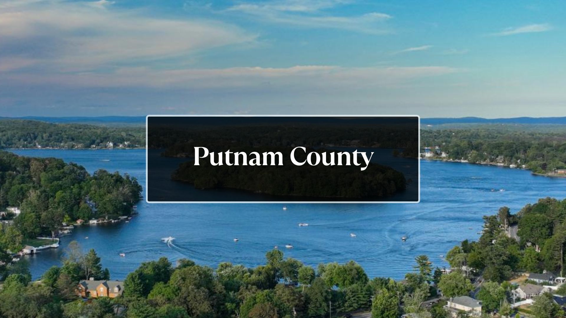 An aerial view of a lake surrounded by trees and houses in putnam county.