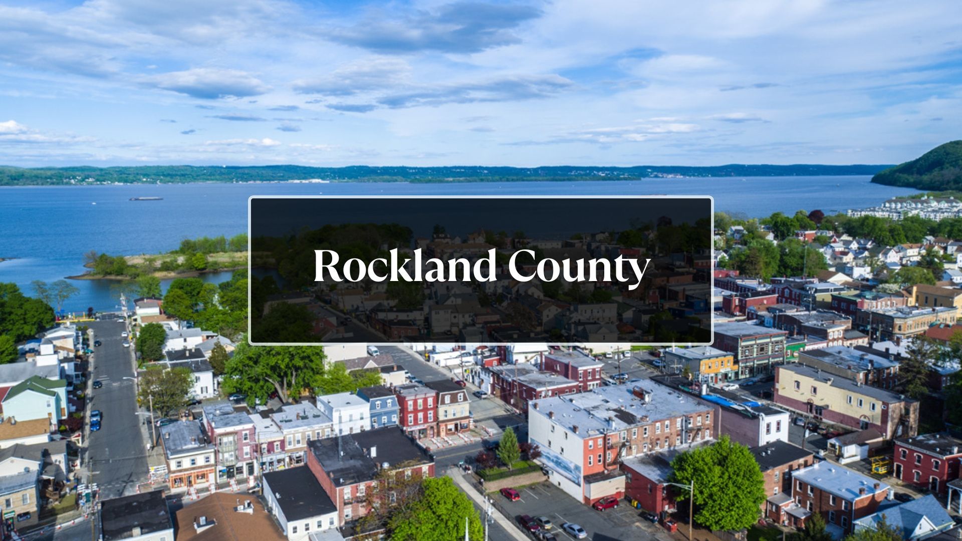 An aerial view of rockland county with a lake in the background.