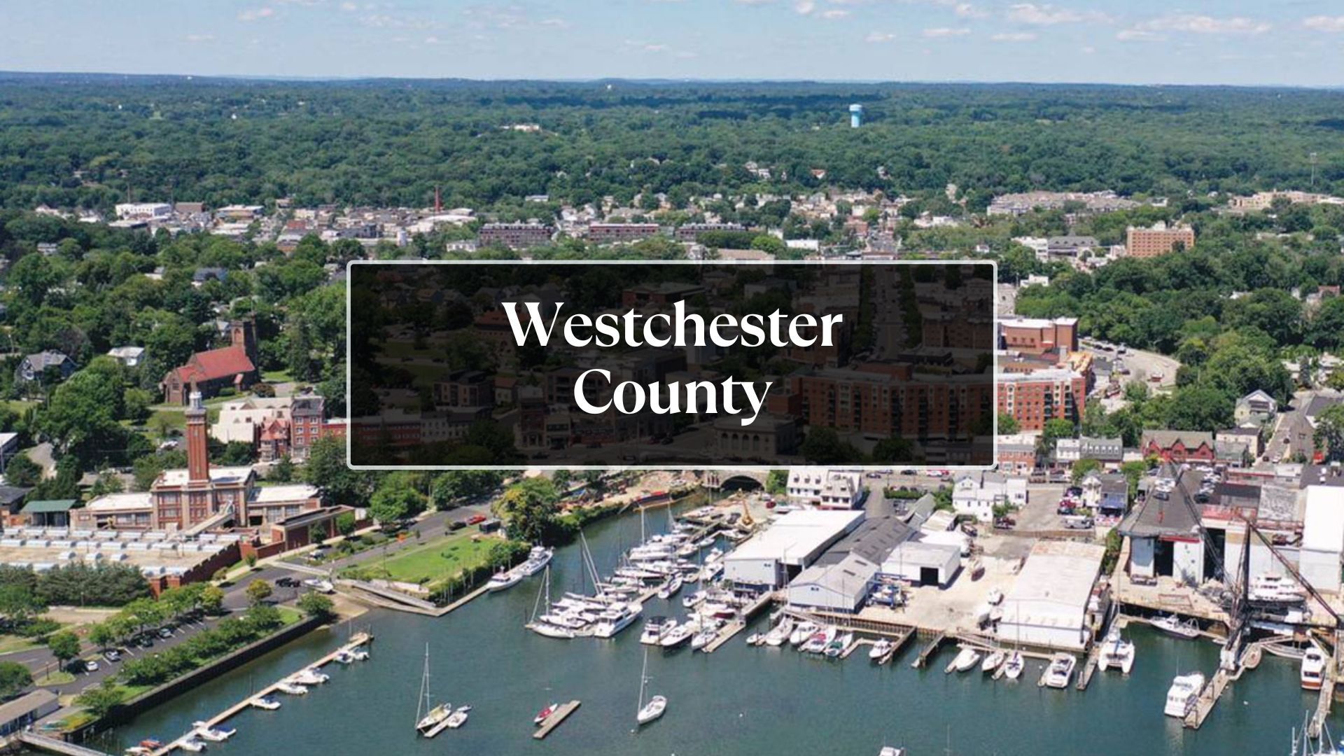 An aerial view of westchester county with boats docked in the water.