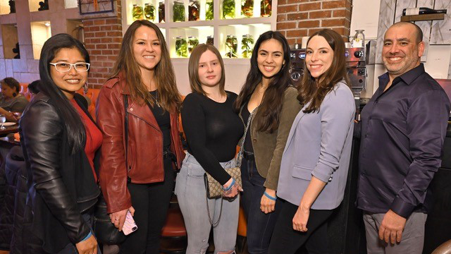 A group of attendees at a YPN event at a restaurant.