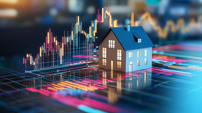A model house is sitting on top of a stock chart.