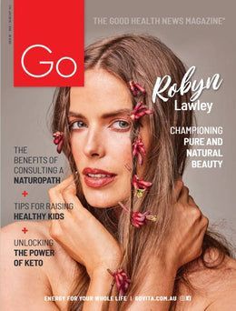 A woman with flowers in her hair is on the cover of a magazine.