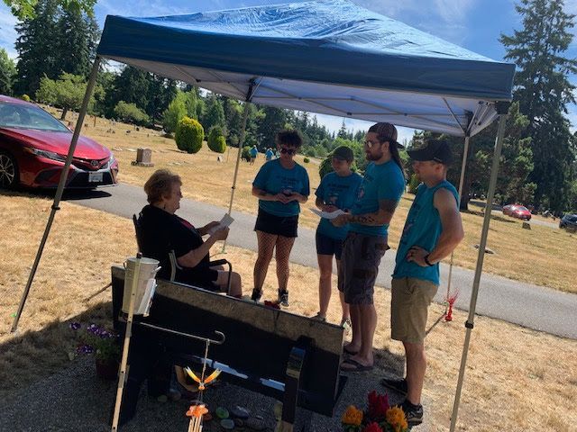 Kyle Kocsis's Grandmother and racers by his bench in Bayview Cemetery Bellingham WA