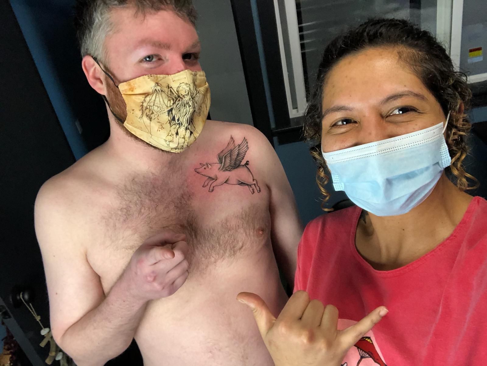 Scott and Susan showing Scott's tattoo