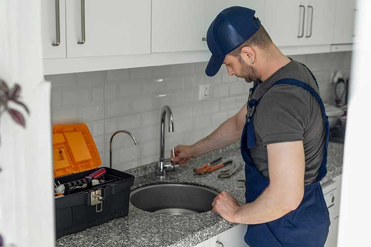 Man Installing New Faucet — Ponte Vedra Beach, FL — Van Worz Plumbing Inc.