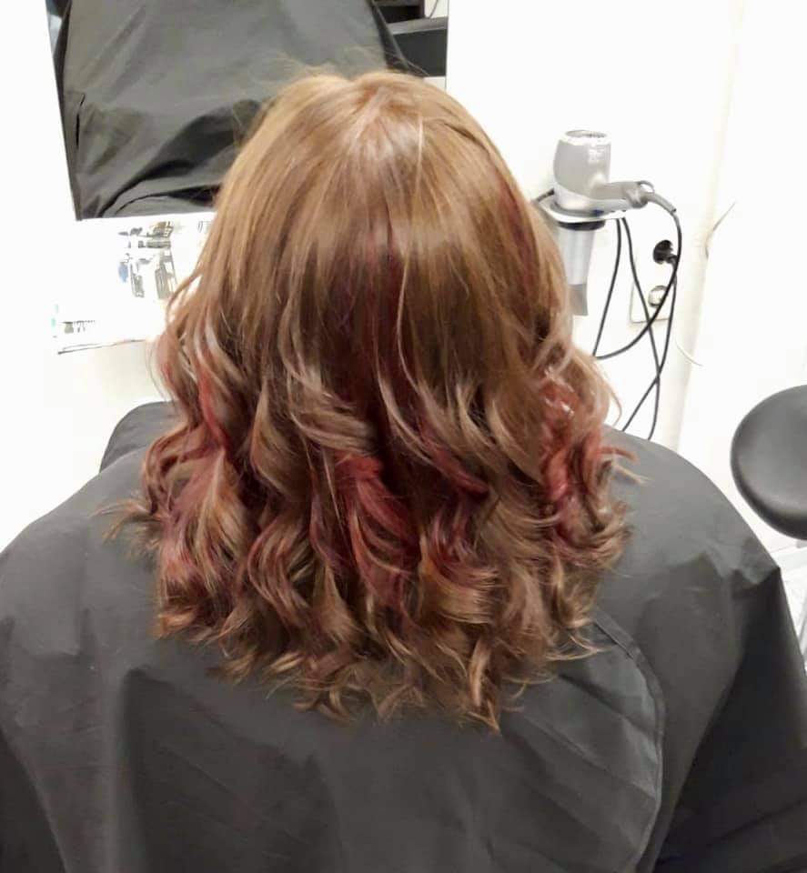 Eine Frau lässt sich in einem Salon die Haare schneiden.