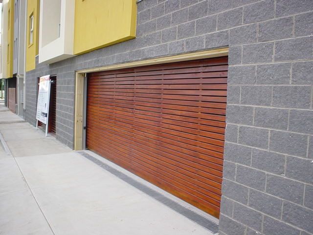 A brick building with a wooden garage door