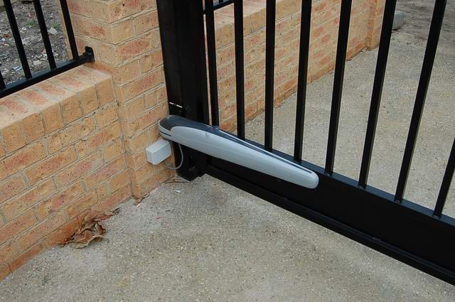 A close up of a gate with a motor attached to it.