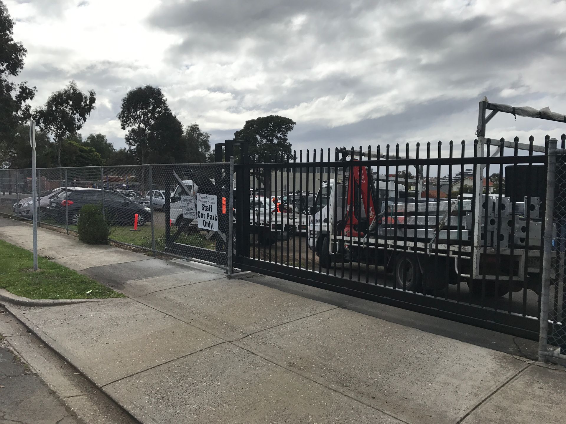 A house with a fence and a sign that says for sale