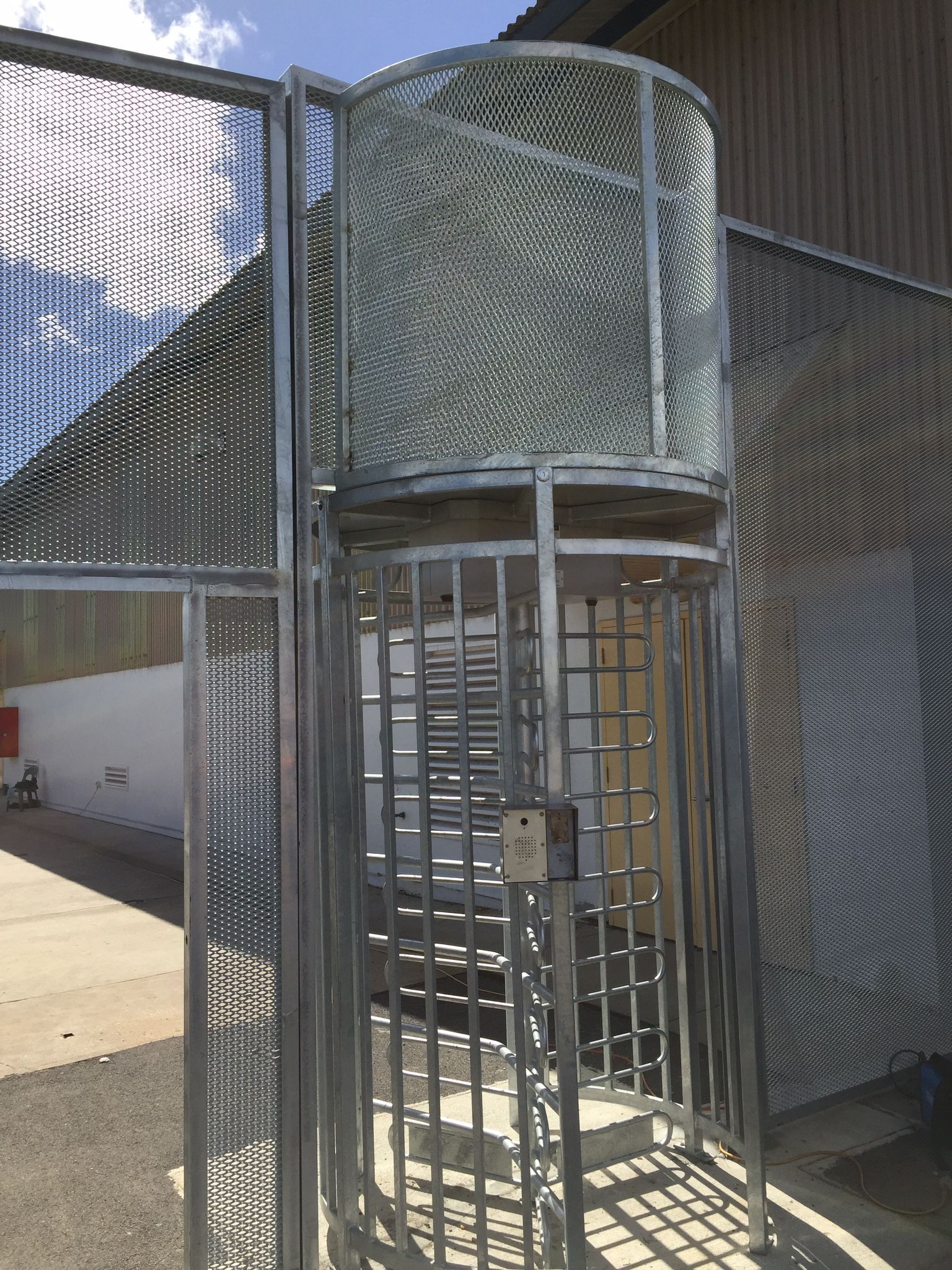 A modern house with a sliding gate in front of it