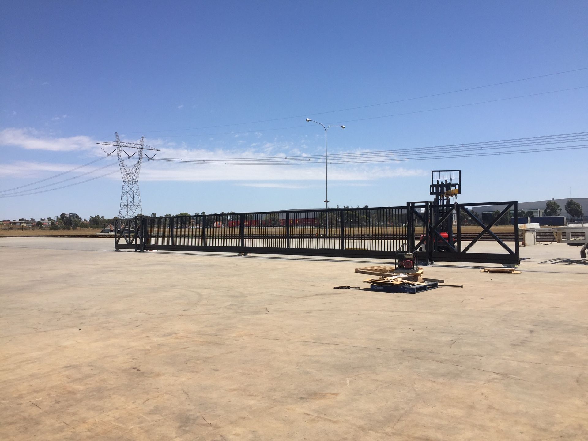 A metal fence with a blue sky in the background