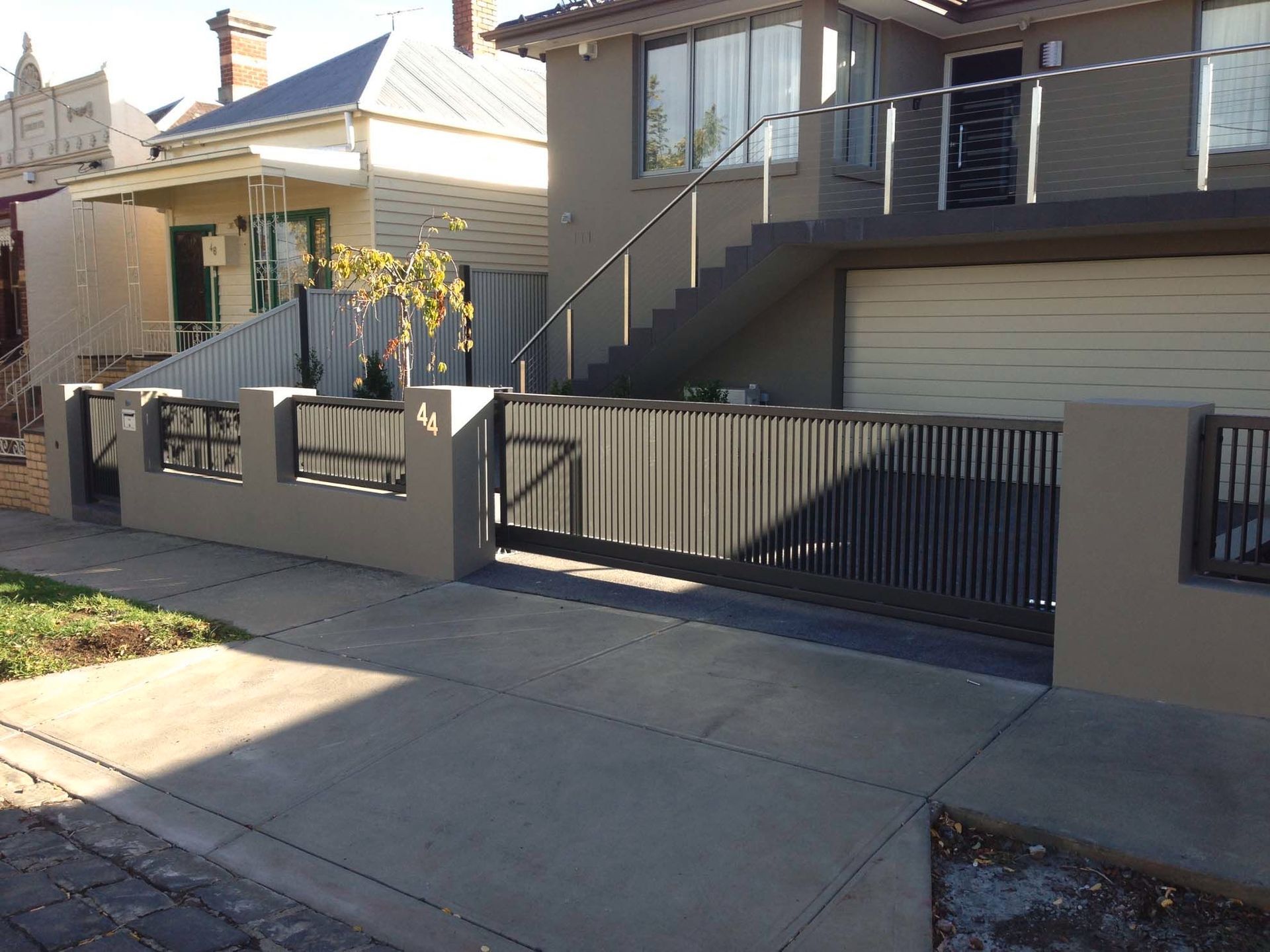 A house with stairs and a fence in front of it