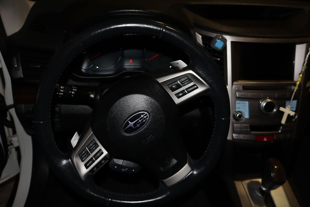 A Subaru steering wheel is shown