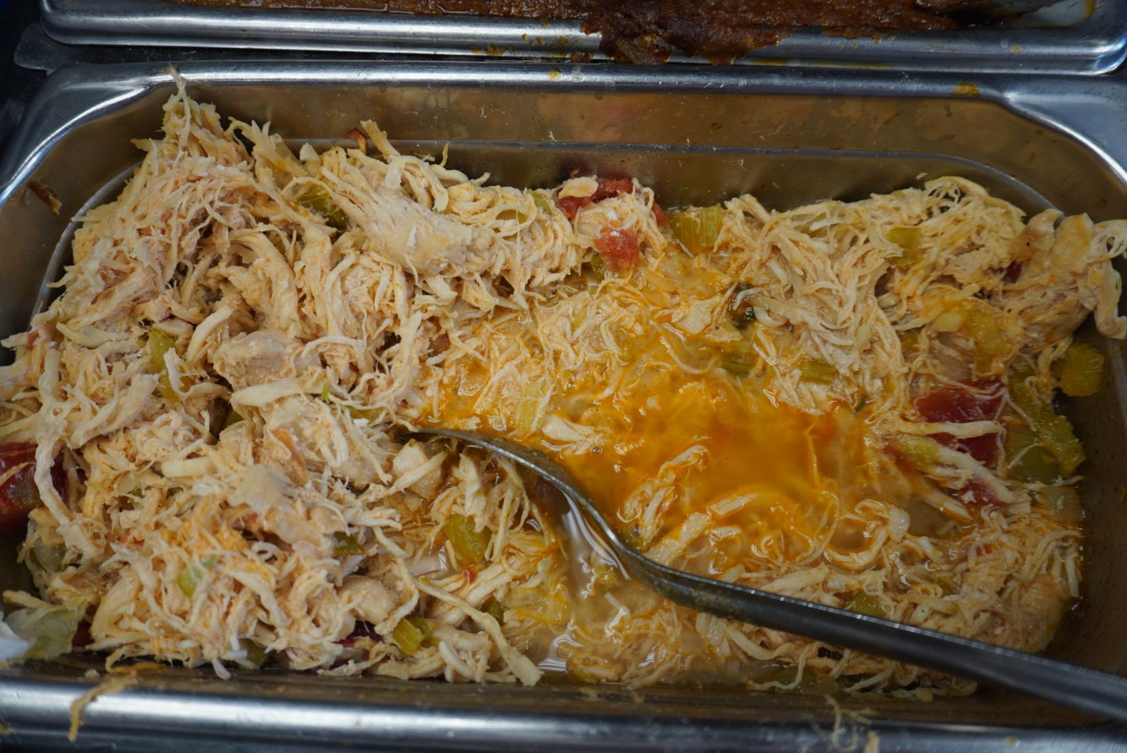 A black el cazador catering truck is parked in the snow