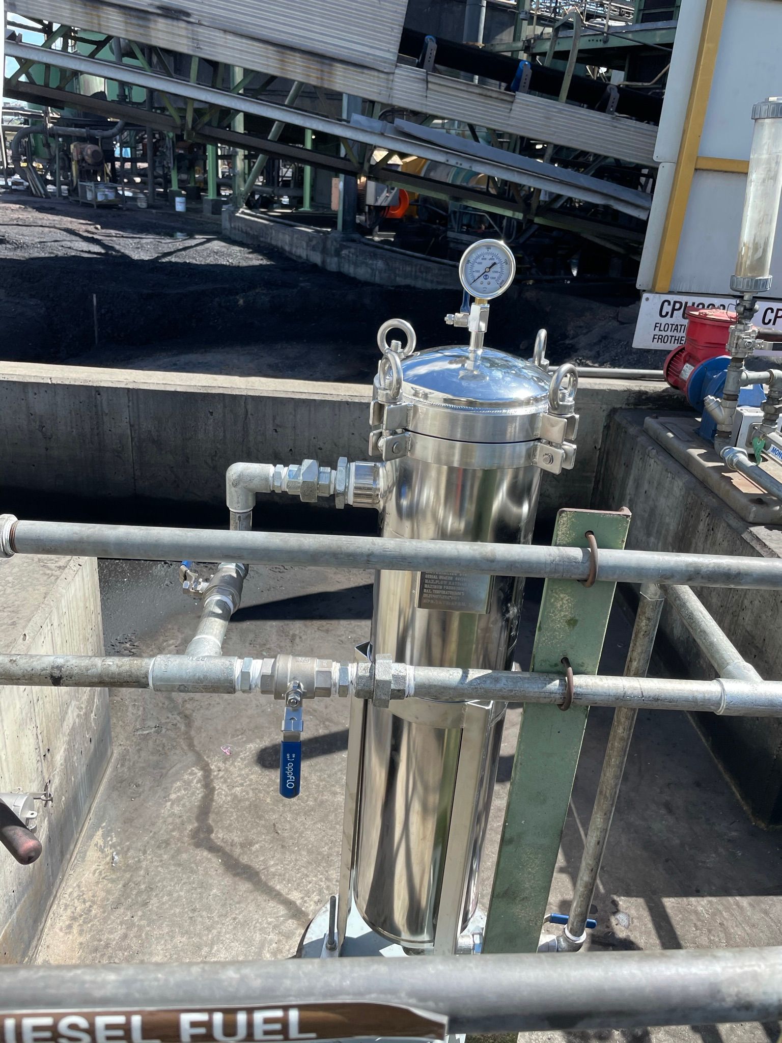 A Bunch of Blue Pipes and Valves Are Sitting on the Ground — Precise Plumbing & Excavations Pty Ltd In Bowen QLD