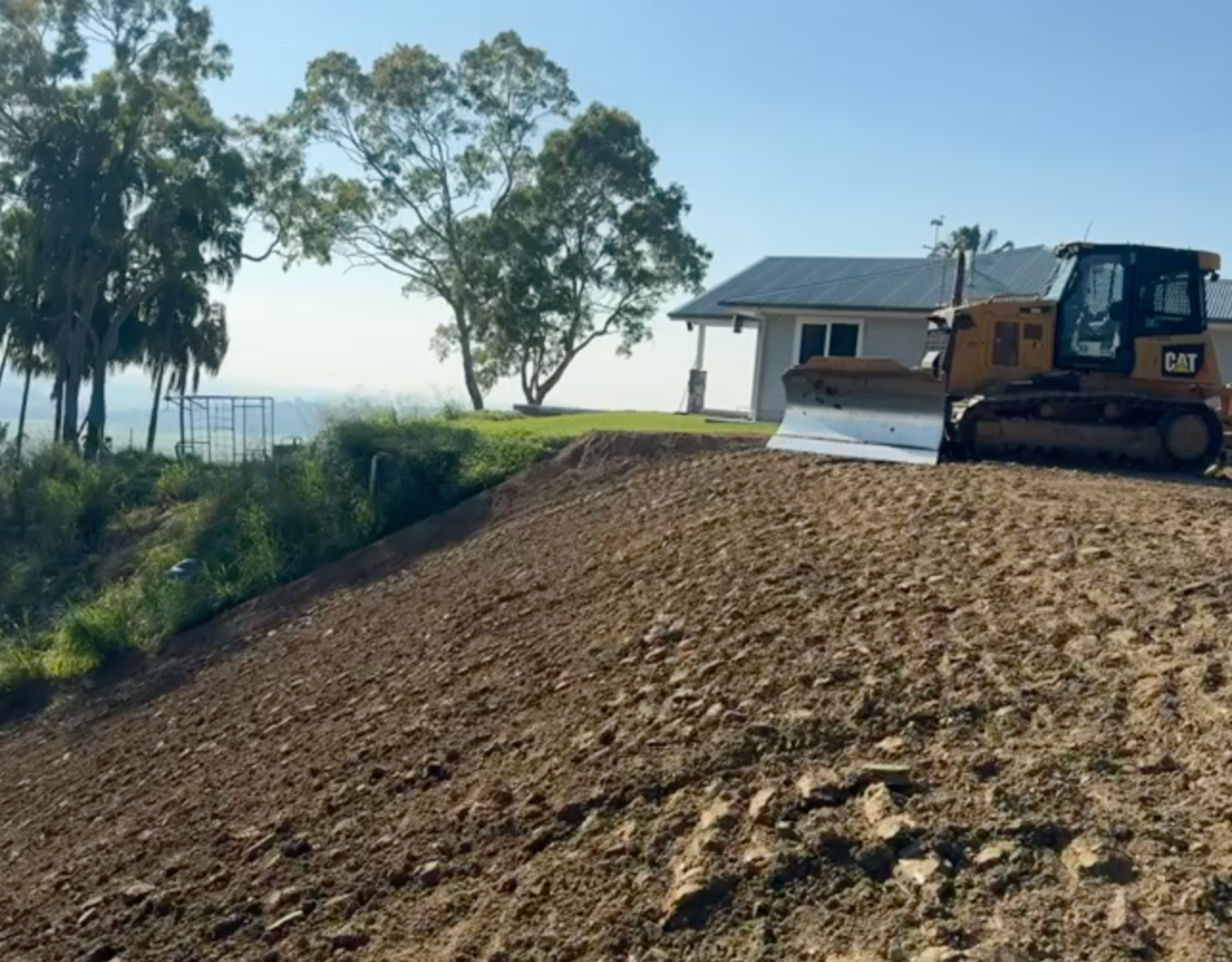 A Person is Cutting a Tree Branch With a Pair of Scissors — Precise Plumbing & Excavations Pty Ltd in Bowen, QLD