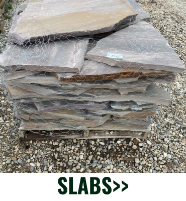 Stacked stone slabs on gravel with “SLABS>>” text below