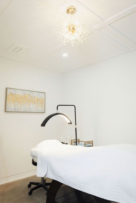 a room with a bed and a lamp in it .