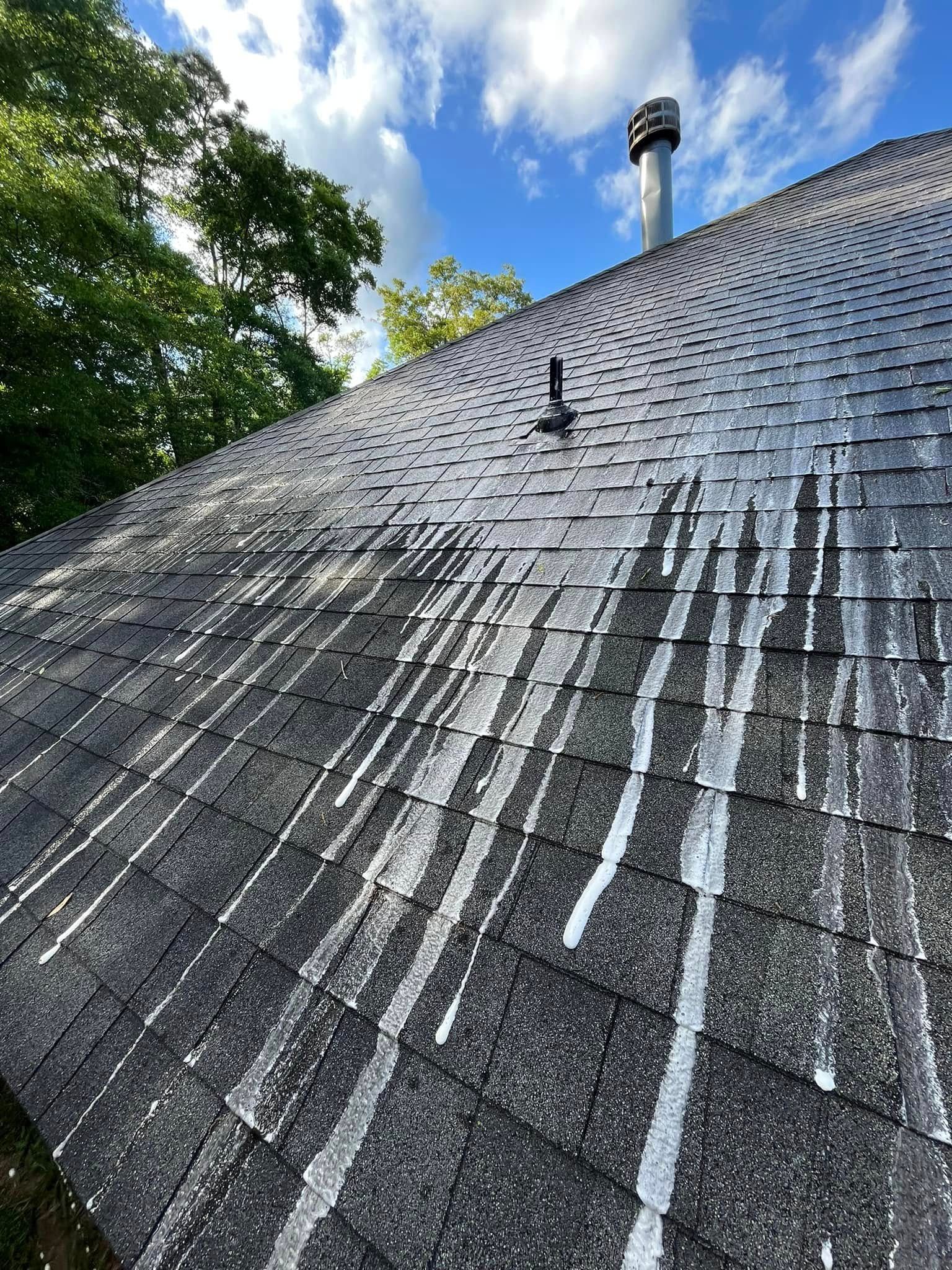 A close up of a roof with a chimney on top of it.