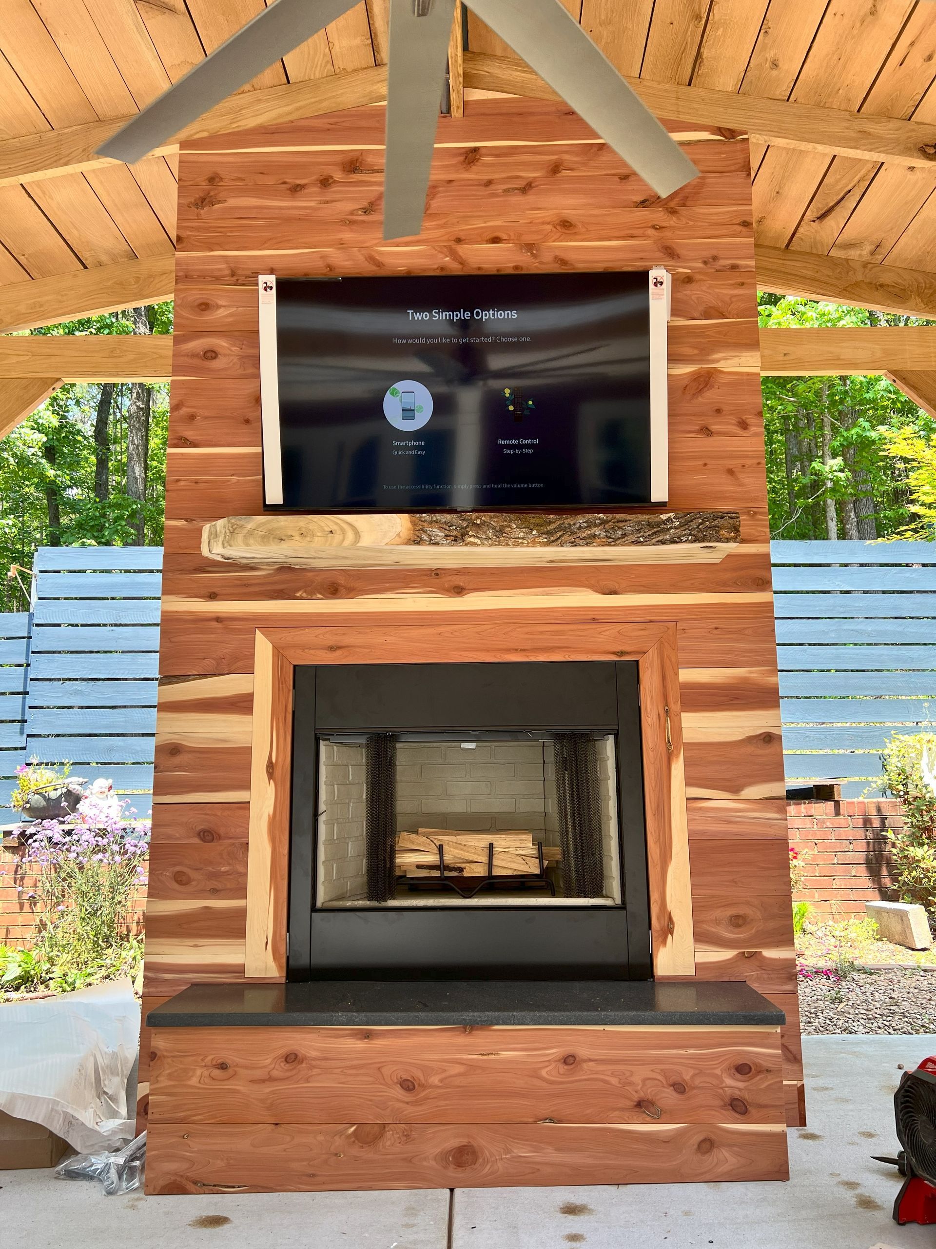 A wooden fireplace with a flat screen tv above it