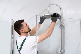 professional plumber installing new shower head