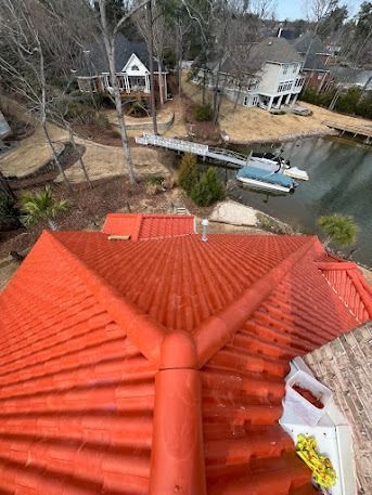 Red roof overlooking a lake with houses and a boat dock.