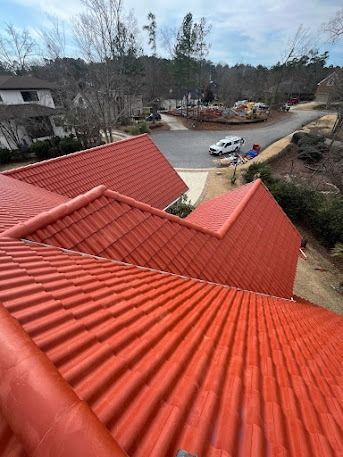 Red tile roof on a house in a suburban setting, overlooking a street and neighborhood.