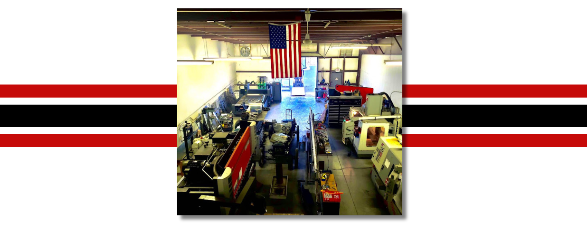 A picture of a factory with an american flag hanging from the ceiling.