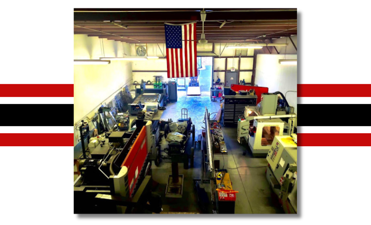 A picture of a factory with an american flag hanging from the ceiling.