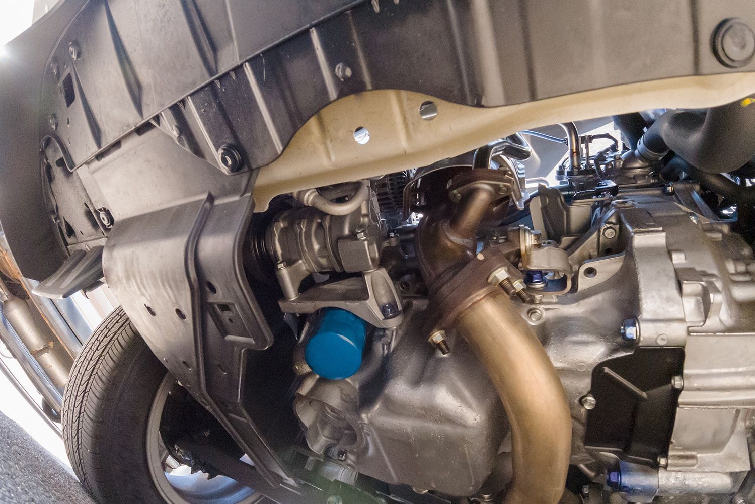 A close up of the underside of a car engine