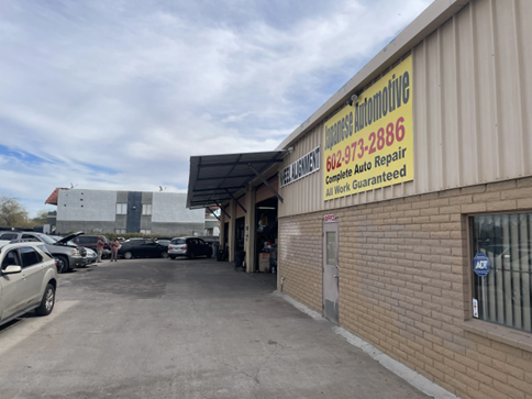 A brick building with cars parked in front of it.